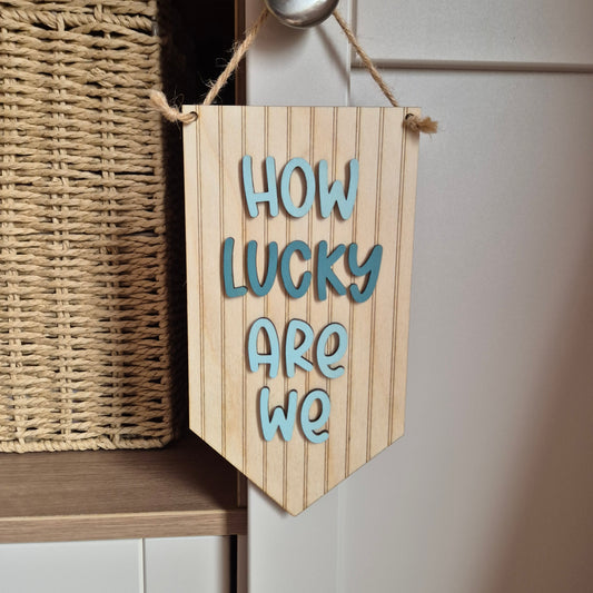 'How Lucky Are We' Wooden Striped Hanging Pennant Sign